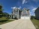 Spacious two-story home featuring a two-car garage and a wide driveway on a sunny day at 8420 Golden Stone Ln # 138, Fort Mill, SC 29707