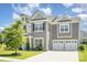 Attractive two-story home with a well-maintained lawn and an attached two-car garage at 8420 Golden Stone Ln # 138, Fort Mill, SC 29707