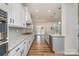 Modern kitchen features white cabinets, granite countertops, stainless steel appliances, and an island sink at 8420 Golden Stone Ln # 138, Fort Mill, SC 29707