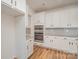 Bright kitchen features white cabinets, granite countertops, stainless steel appliances, and hardwood flooring at 8420 Golden Stone Ln # 138, Fort Mill, SC 29707