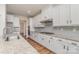 Bright kitchen features white cabinets, granite countertops, stainless steel appliances, and hardwood flooring at 8420 Golden Stone Ln # 138, Fort Mill, SC 29707