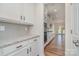 Modern kitchen features white cabinets, granite countertops, stainless steel appliances and hardwood flooring at 8420 Golden Stone Ln # 138, Fort Mill, SC 29707