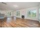 Open-concept living space showcases hardwood floors, fireplace, and seamless transition to the kitchen at 8420 Golden Stone Ln # 138, Fort Mill, SC 29707
