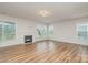 Spacious living room features a cozy fireplace, gleaming hardwood floors, and an abundance of natural light at 8420 Golden Stone Ln # 138, Fort Mill, SC 29707