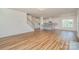 Open-concept living space with hardwood floors, kitchen island, and abundant natural light at 8420 Golden Stone Ln # 138, Fort Mill, SC 29707