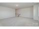 Spacious loft features neutral walls and carpet, a stairway and recessed lighting at 8420 Golden Stone Ln # 138, Fort Mill, SC 29707