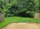 Landscaped backyard with a small patio area and lush greenery at 8904 Daventry Pl, Charlotte, NC 28215