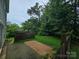Lush backyard with a wooden fence and mature trees at 8904 Daventry Pl, Charlotte, NC 28215