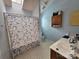 Cozy bathroom featuring a shower with butterfly curtain, vanity, and a skylight at 8904 Daventry Pl, Charlotte, NC 28215
