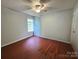 Empty bedroom boasting hardwood floors, a ceiling fan, and a bright window at 8904 Daventry Pl, Charlotte, NC 28215