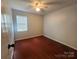 Bedroom featuring hardwood floors, a ceiling fan, and a window letting in natural light at 8904 Daventry Pl, Charlotte, NC 28215