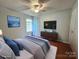 Staged bedroom featuring hardwood floors, neutral walls, and coordinated decor at 8904 Daventry Pl, Charlotte, NC 28215