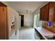 Bright eat-in kitchen with white appliances, access to outdoor patio and ample natural light at 8904 Daventry Pl, Charlotte, NC 28215