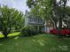 Charming two-story home with well-manicured lawn and mature trees in a quiet neighborhood at 8904 Daventry Pl, Charlotte, NC 28215