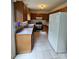 Functional kitchen with laminate counters, basic appliances, and tile flooring at 8904 Daventry Pl, Charlotte, NC 28215