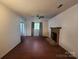 Traditional living room offering sleek wood floors, brick fireplace and ample natural light at 8904 Daventry Pl, Charlotte, NC 28215