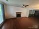Comfortable living room with brick fireplace, sleek wood flooring and bright natural light at 8904 Daventry Pl, Charlotte, NC 28215