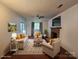 Comfortable living room with a brick fireplace, neutral paint, and nice wood flooring at 8904 Daventry Pl, Charlotte, NC 28215