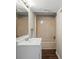 Bathroom features a tub and shower combo, single sink vanity and dark wood flooring at 904 Edgewood Cir, Gastonia, NC 28052