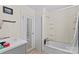 Bright bathroom features a vanity, toilet, shower and bathtub combination at 904 Edgewood Cir, Gastonia, NC 28052