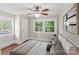 Cozy bedroom with plush bed, hardwood floors, and natural light from two windows at 904 Edgewood Cir, Gastonia, NC 28052