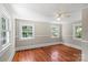 Inviting bedroom featuring three large windows, neutral paint, and hardwood floors at 904 Edgewood Cir, Gastonia, NC 28052