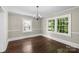 Bright dining room with hardwood floors, neutral walls, and two sets of windows at 904 Edgewood Cir, Gastonia, NC 28052
