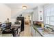 Well-lit kitchen with black appliances, laminate floors, and window above the sink at 904 Edgewood Cir, Gastonia, NC 28052