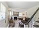 Living room with dark brown sofa and staircase at 904 Edgewood Cir, Gastonia, NC 28052