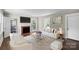 Bright living room with fireplace, hardwood floors, and large windows, creating a warm, inviting space at 904 Edgewood Cir, Gastonia, NC 28052