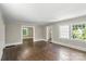 Inviting living room featuring hardwood floors, neutral walls, and sunlit windows for a bright, airy ambiance at 904 Edgewood Cir, Gastonia, NC 28052