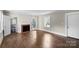 Spacious living room boasts hardwood floors, large windows, and a charming fireplace with traditional mantel at 904 Edgewood Cir, Gastonia, NC 28052