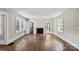 Bright living room with original hardwood floors, a fireplace, and large windows offering plenty of natural light at 904 Edgewood Cir, Gastonia, NC 28052