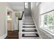 Classic staircase with white risers, black treads, and a large window at 904 Edgewood Cir, Gastonia, NC 28052