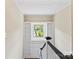 Staircase with built-in bookshelves leading to a window and attic access at 904 Edgewood Cir, Gastonia, NC 28052