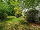 Backyard features lush green lawn with mature trees providing lots of shade and privacy at 9212 John Hawks Rd, Cornelius, NC 28031