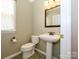 Bathroom with pedestal sink, tile floors, and modern fixtures at 9212 John Hawks Rd, Cornelius, NC 28031