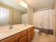 Bathroom features a double sink vanity, large mirror, and shower with curtain at 9212 John Hawks Rd, Cornelius, NC 28031