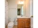 Cozy bathroom featuring a single sink vanity, toilet, and shower with curtain at 9212 John Hawks Rd, Cornelius, NC 28031