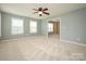 Lovely bedroom featuring carpet, ceiling fan, and multiple windows offering ample natural light at 9212 John Hawks Rd, Cornelius, NC 28031