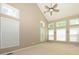Bright bedroom with vaulted ceilings, ceiling fan, and multiple windows letting in natural light at 9212 John Hawks Rd, Cornelius, NC 28031