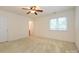 Bright bedroom with neutral carpet, ceiling fan, window, and ensuite bathroom at 9212 John Hawks Rd, Cornelius, NC 28031