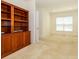 Bedroom with large window, neutral carpet, and built in shelves for organization and display at 9212 John Hawks Rd, Cornelius, NC 28031