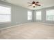 Large bedroom with carpet, a ceiling fan, and plenty of natural light from multiple windows at 9212 John Hawks Rd, Cornelius, NC 28031