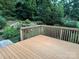 Spacious wooden deck with a wood railing overlooks a lush green landscape, perfect for outdoor relaxation at 9212 John Hawks Rd, Cornelius, NC 28031