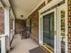 Inviting front porch featuring rocking chairs, brick columns, and a view of the front door at 9212 John Hawks Rd, Cornelius, NC 28031