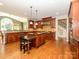 Large kitchen featuring wood cabinets, granite counters, stainless appliances, and hardwood floors at 9212 John Hawks Rd, Cornelius, NC 28031