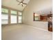 Spacious living room with vaulted ceilings, a ceiling fan, lots of windows, and a view to the kitchen at 9212 John Hawks Rd, Cornelius, NC 28031