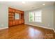 Open living area with hardwood floors, custom built-ins, and natural light at 9212 John Hawks Rd, Cornelius, NC 28031