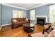 Cozy living room features a fireplace, hardwood floors, and plenty of seating at 9212 John Hawks Rd, Cornelius, NC 28031